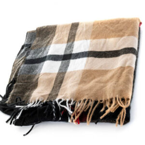 Tartan shawl in front of white background,