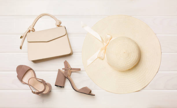 Fashionable leather bag with shoes on color background, top view